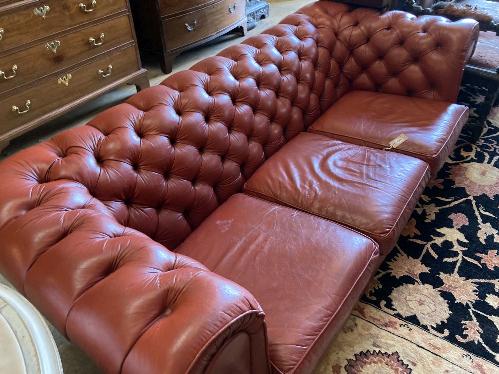 A three seater buttoned red leather chesterfield settee, length 210cm, depth 90cm, height 68cm